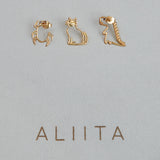 Gold earrings shaped like a scarab beetle, a cat, a dinosaur