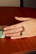 Load image into Gallery viewer, Hand wearing a gold ring with a red coral watermelon slice and a round ring with malachite stone
