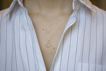 Load image into Gallery viewer, Gold chain necklace with family shaped pendant worn by model
