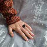 Gold ring with black agate and malachite stones worn by model