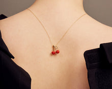 Load image into Gallery viewer, Woman shot from the back wearing a gold chain necklace with two cherries in red coral
