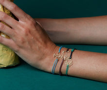Carica l&#39;immagine nel visualizzatore di Gallery, Burgundy cord bracelet with cat shaped pendant worn by model
