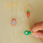 Gold jewelry composition with fruit shaped coral and turquoise 