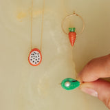 Gold jewelry composition with fruit shaped coral and turquoise 