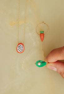Gold jewelry composition with fruit shaped coral and turquoise 