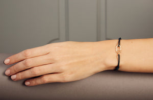 Bottle green cord bracelet with stracciatella ice pop pendant on model's wrist on woman's wrist