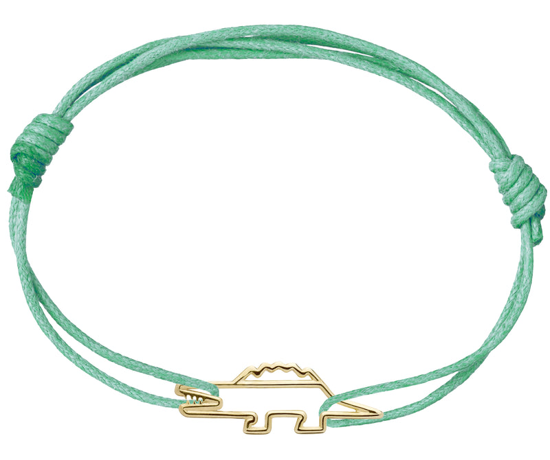 Mint green cord bracelet with a crocodile shaped gold pendant