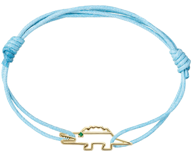 Sky blue cord bracelet with a gold shaped crocodile with a small emerald eye