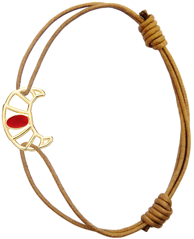Brown cord bracelet with gold croissant shaped pendant hand-painted in raspberry enamel