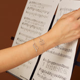 white gold chain bracelets with dinosaur and house shaped pendants