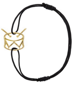 Black eco cord bracelet with gold drum shaped pendant