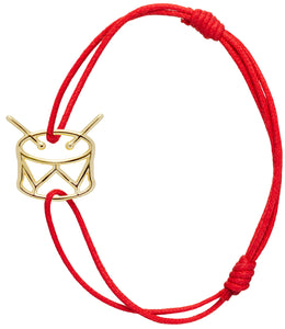 Red cord bracelet with gold drum shaped pendant