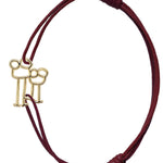 Burgundy cord bracelet with family shaped gold pendant
