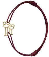 Load image into Gallery viewer, Burgundy cord bracelet with family shaped gold pendant
