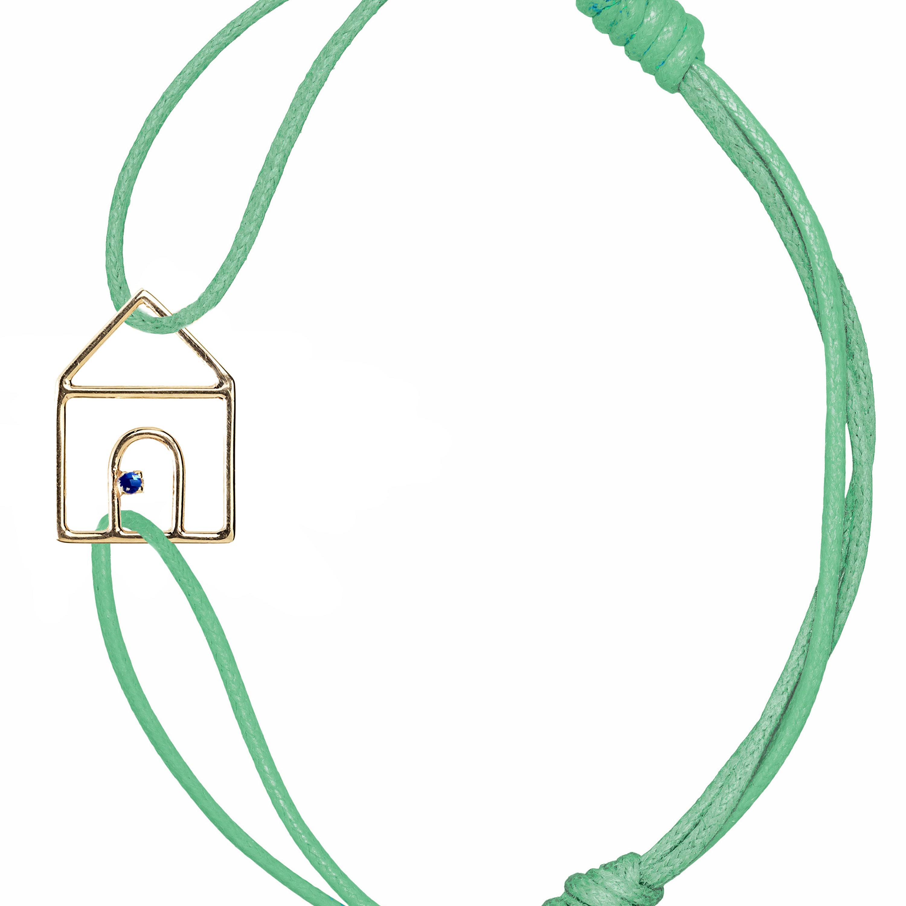 Mint green cord bracelet with gold house shaped pendant and small blue sapphire