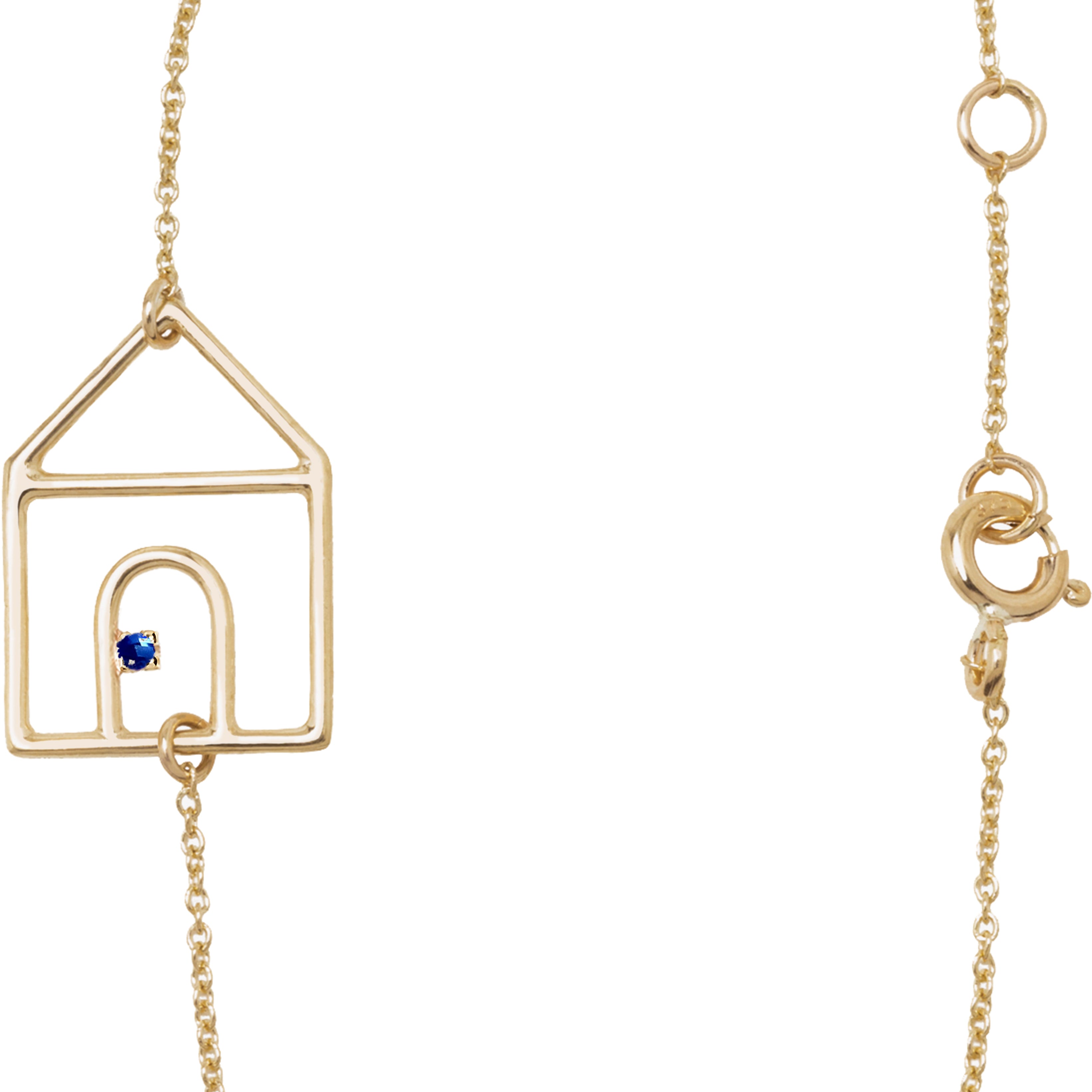 Gold chain bracelet with house shaped pendant and small blue sapphire
