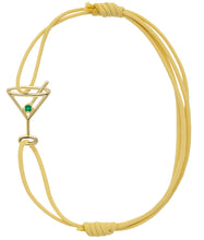 Load image into Gallery viewer, Light yellow eco cord bracelet with a martini drink shaped gold pendant with an small emerald
