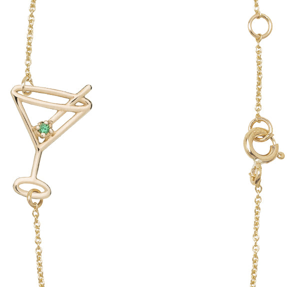 Gold chain bracelet with martini drink shaped pendant  and small emerald