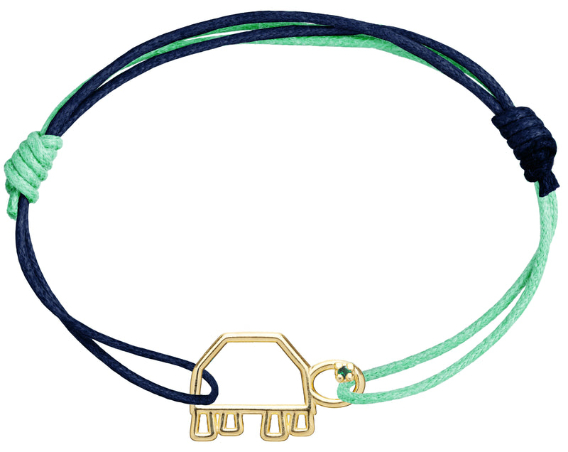 Blue and green cord bracelet with a small turtle shaped gold pendant with an emerald eye