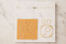 Carica l&#39;immagine nel visualizzatore di Gallery, Jewelry composition with gold hoop rings, earrings and bracelets
