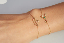 Load image into Gallery viewer, Gold chain bracelet with martini drink shaped pendant and small emerald worn by model
