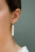 Load image into Gallery viewer, Gold earrings with long rectangular white agate stones worn by model
