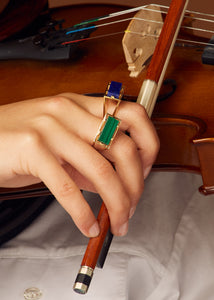 Gold square rings with lapis lazuli and malachite stones on model's hand