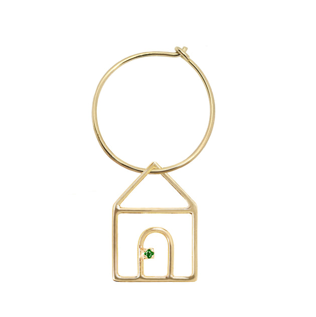 Gold earring circle with house shaped pendant and small emerald
