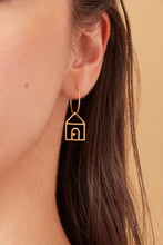 Load image into Gallery viewer, Gold hoop earring with house shaped pendant and small diamond worn by model
