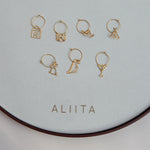 Gold hoop earrings with gold pendants and precious stones