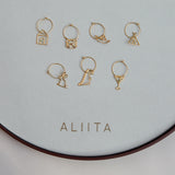 Gold hoop earrings with gold pendants and precious stones