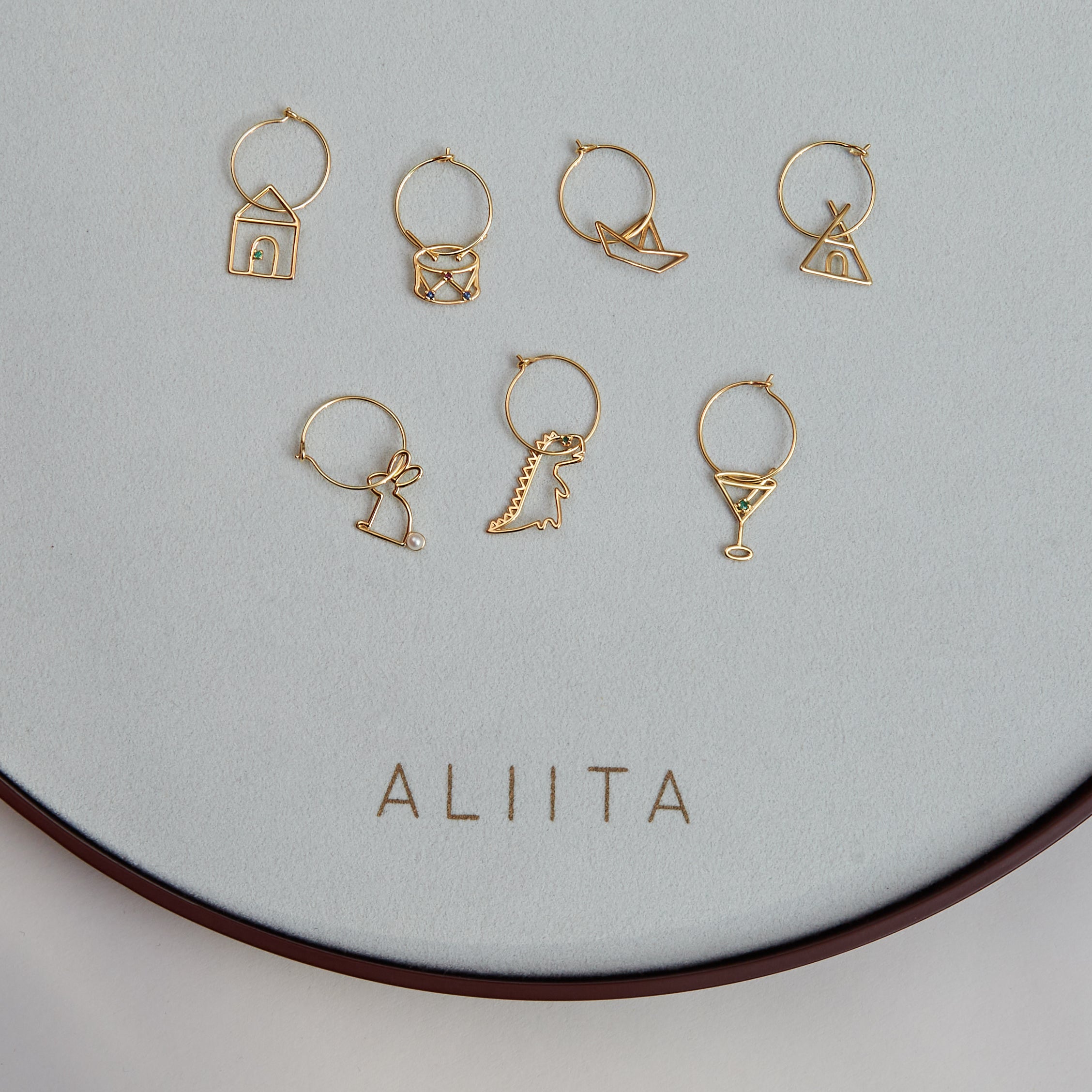Gold hoop earrings with gold pendants and precious stones