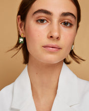 Load image into Gallery viewer, Model wearing gold earrings with broccoli shaped cameo in green porcelain
