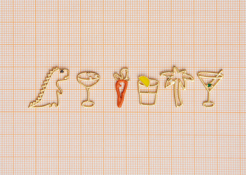 Jewelry gold pendants shaped like dinosaur. palm tree, carrot, tequila shot, martini drink, champagne glass