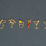 Jewelry gold pendants shaped like dinosaur. palm tree, carrot, tequila shot, martini drink