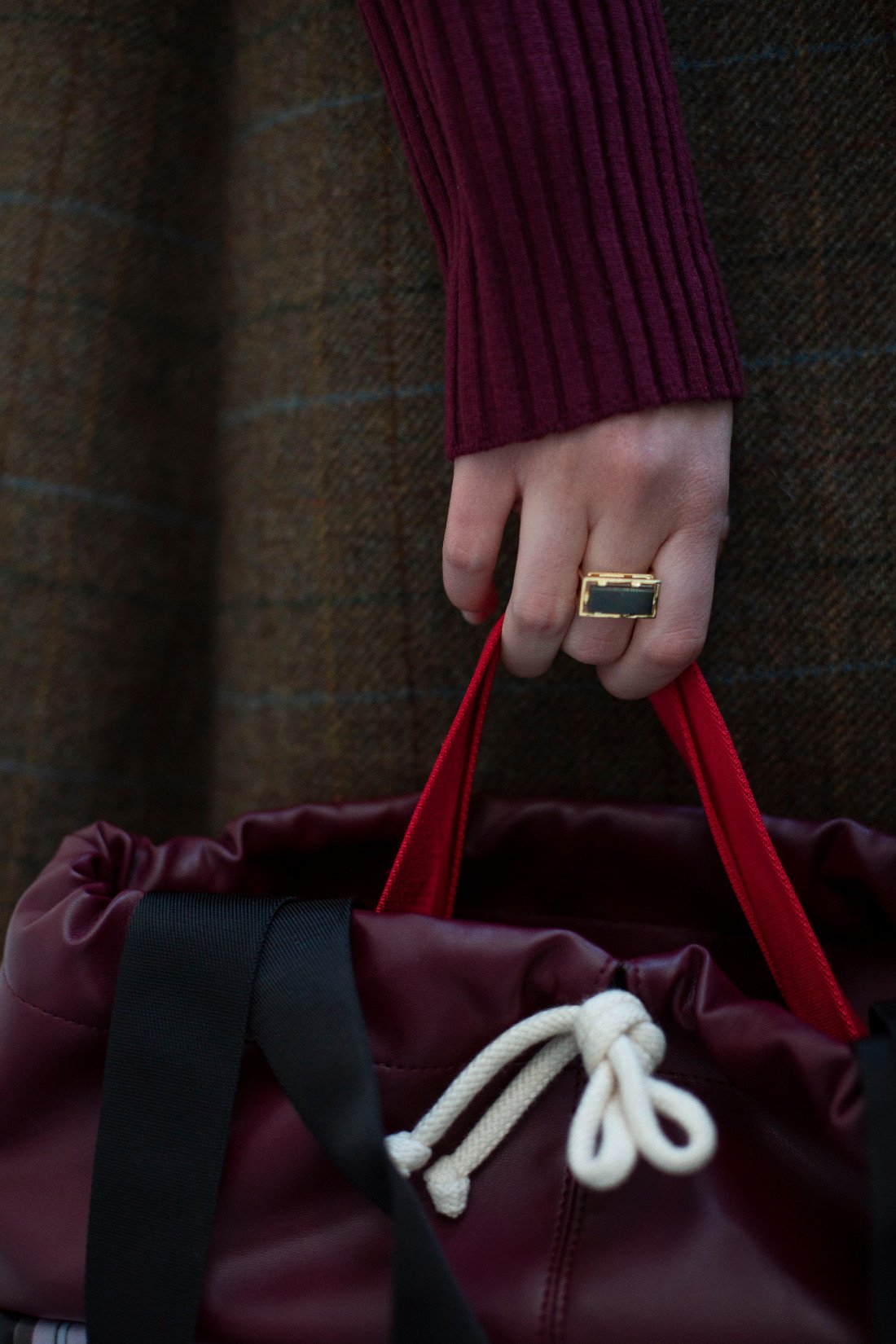 Gold square rings with jasper stone worn by model