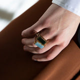 Gold square rings with jasper stone and blue jade worn by model