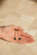 Load image into Gallery viewer, Hands holding long gold earrings with cylinder cut malachite stones
