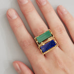 Gold square rings with lapis lazuli and malachite stones worn by model