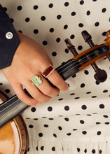 Load image into Gallery viewer, Hand holding violin wearing gold rings with hard stones
