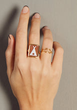 Load image into Gallery viewer, Hand wearing a tepee cameo on shell gold ring and a crocodile shaped gold ring
