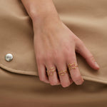 Gold dog shaped ring and small diamond worn by model