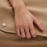 Gold dog shaped ring and small diamond worn by model