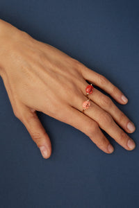 Gold rings with mini pink crab shaped coral worn by model