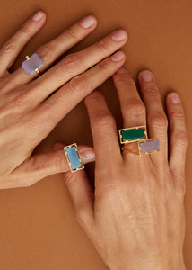 Gold rings with hard and precious stones on hands