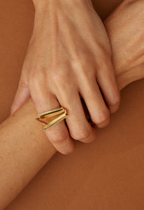 Gold ring with triangular cut citrine stone on woman's hand