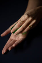 Load image into Gallery viewer, Hands wearing gold rings shaped like dinosaur and star
