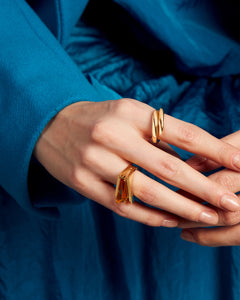 Woman wearing two gold rings with citrine stone