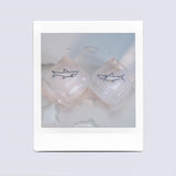White gold shark shaped pendants on ice cubes