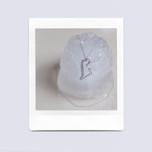 Load image into Gallery viewer, White gold chain necklace with dinosaur shaped pendant and small diamond on ice cubes
